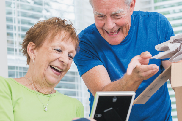 Older people packing moving boxes